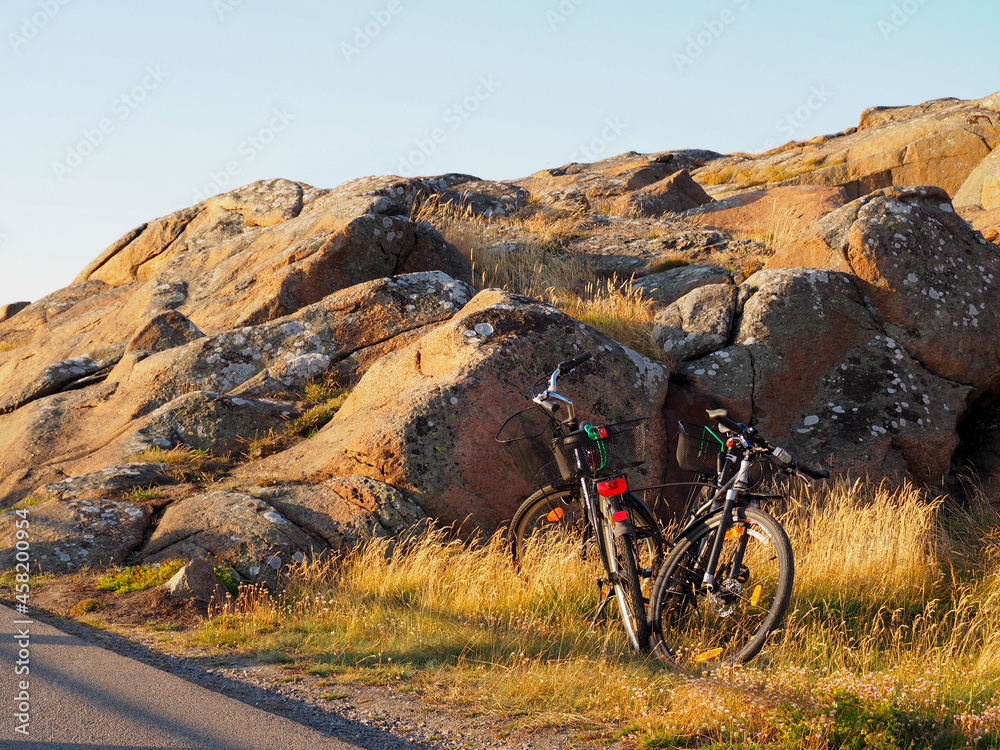 Bicycles near to the rock in the beach in Sweden during summer in varberg Bicycles near to the rock in the beach in Sweden during summer in varberg