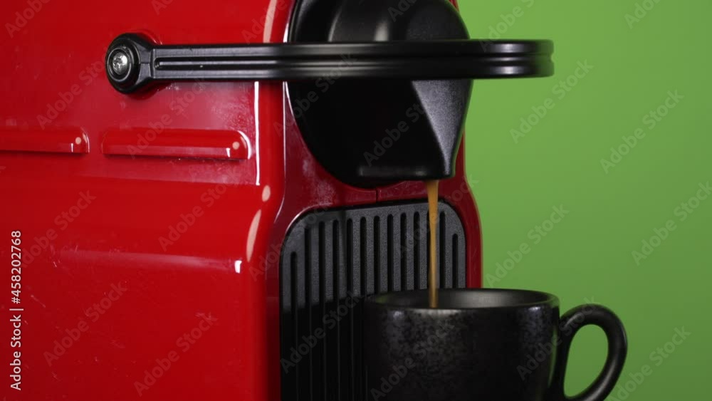 Nespresso Machine making coffee in front of chroma green screen Nespresso Machine making coffee in front of chroma green screen