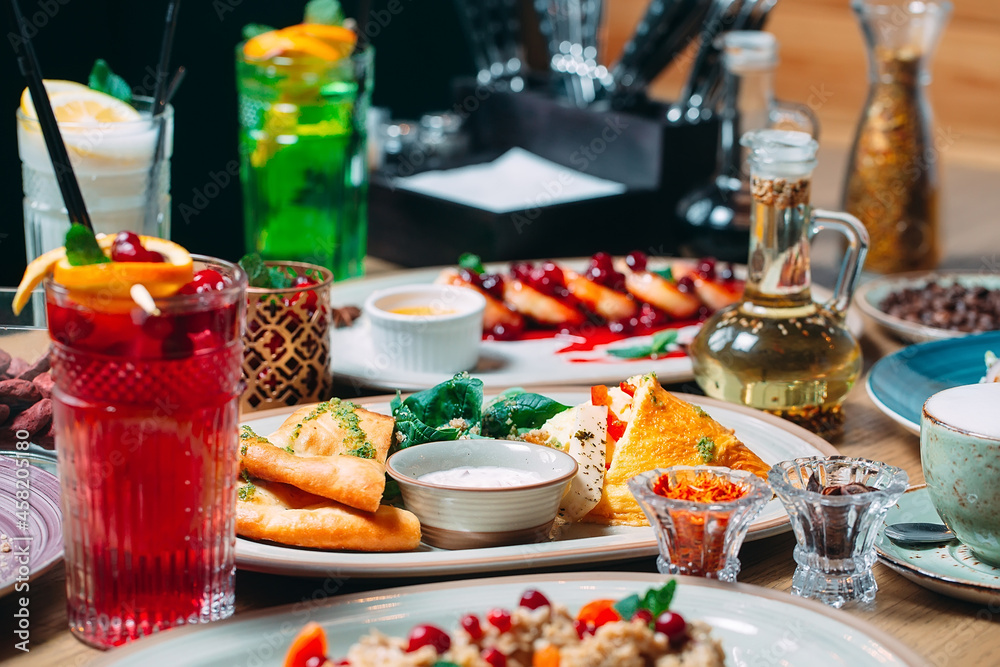 Various breakfast dishes are served on the table in the restaurant. Various breakfast dishes are served on the table in the restaurant.