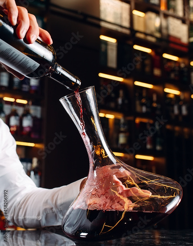 Young handsome man sommelier tasting red wine in cellar.