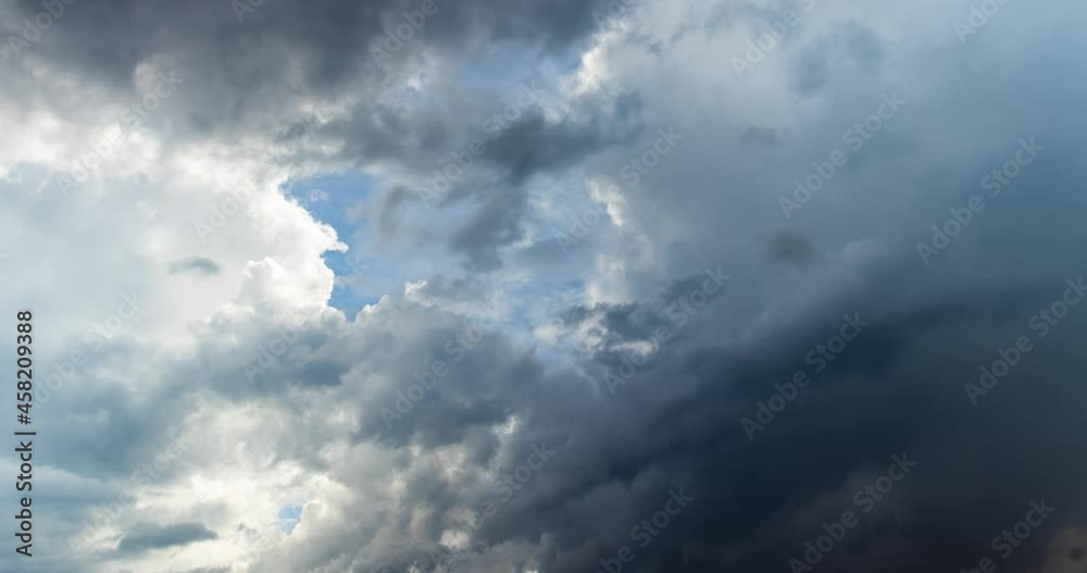 Dark storm rain clouds time lapse over blue sunny sky weather change