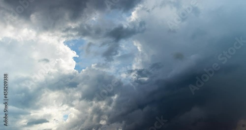 Dark storm rain clouds time lapse over blue sunny sky weather change