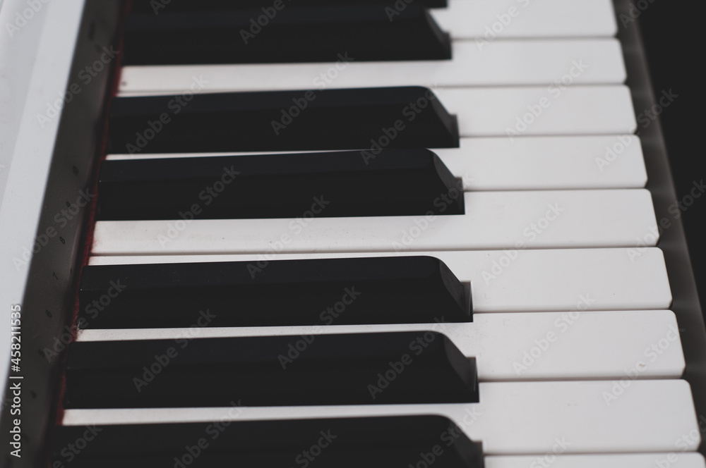 Side view. Black-white piano keys close-up classical musical instrument. Side view. Black-white piano keys close-up classical musical instrument.