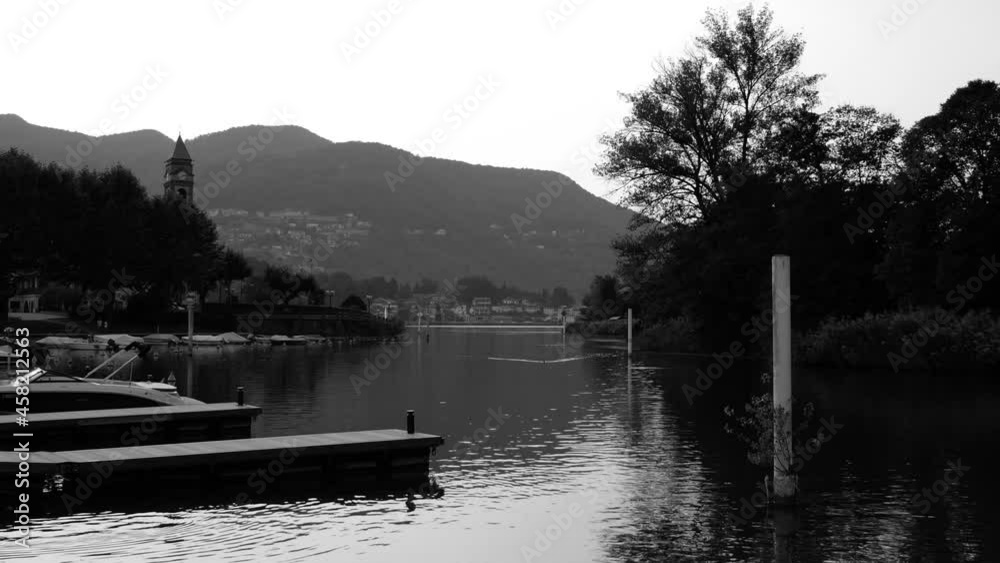 International Border on Lake Lugano Between Italy and Switzerland with Mountain in Sunset in Lavena and Caslano, Lombardy and Ticino. International Border on Lake Lugano Between Italy and Switzerland with Mountain in Sunset in Lavena and Caslano, Lombardy and Ticino.