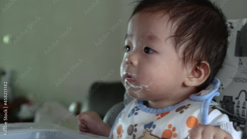 7 month old Cute Little Asian Chinese Baby Eating His Dinner. 4k. Child eat porridge. 7 month old Cute Little Asian Chinese Baby Eating His Dinner. 4k. Child eat porridge.