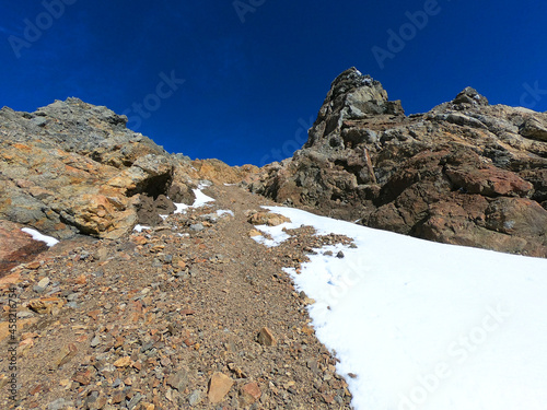 Stones and snow on the way to the top of Piltriquitron hill near the Argentine town of El Bolson photo