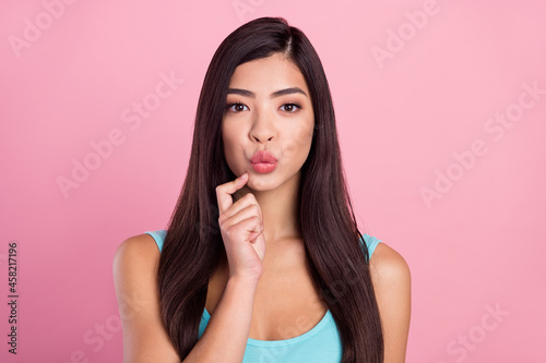 Photo of thinking young brown hairdo lady finger face wear blue top isolated on pastel pink color background