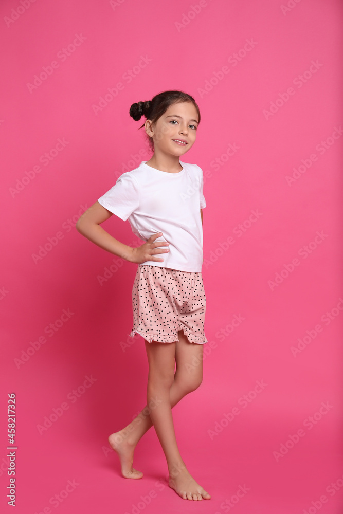 Cute girl in pajamas on pink background Cute girl in pajamas on pink background