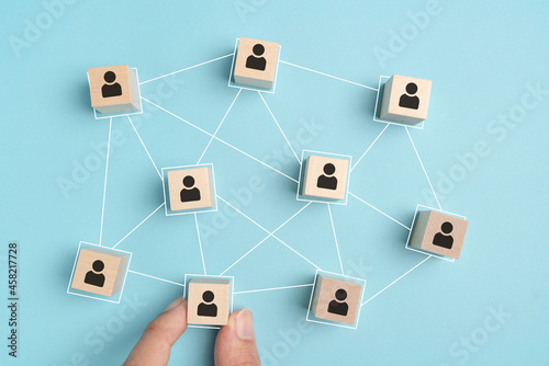 building a good team , Wooden blocks with people icon on blue background, Human resources and management concept.