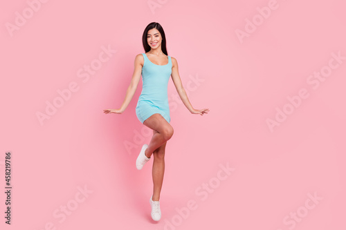 Full body photo of funky millennial lady jump wear blue dress isolated on pink color background