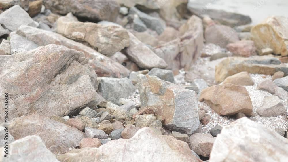 Natural background of a big rocks or pebbles on the seashore close-up. The surface of the beach on the ocean is covered with large stones of gray color of different sizes Natural background of a big rocks or pebbles on the seashore close-up. The surface of the beach on the ocean is covered with large stones of gray color of different sizes