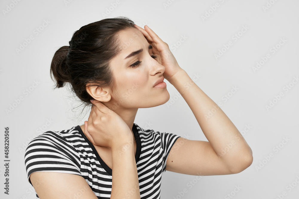 brunette in a striped t-shirt pain in the neck health problems brunette in a striped t-shirt pain in the neck health problems