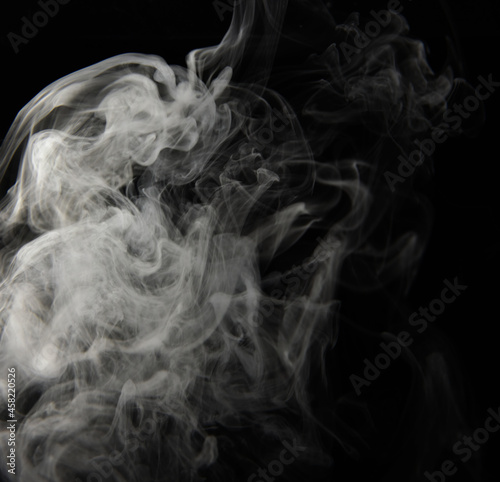 clouds of white smoke on a black background