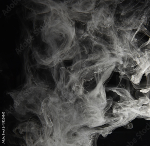 clouds of white smoke on a black background
