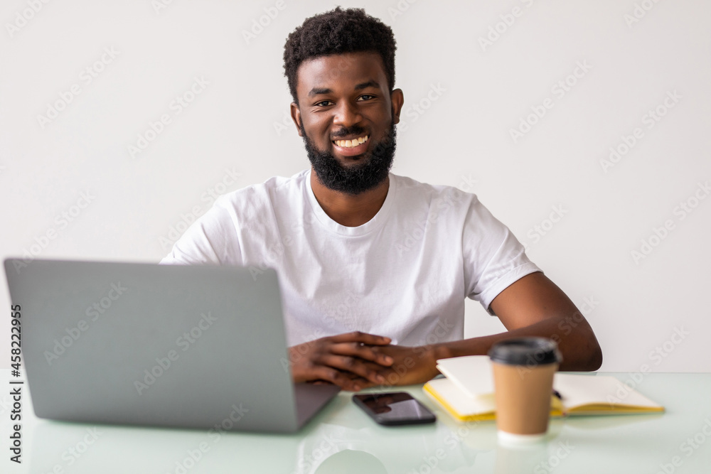 Young man typing on laptop in the office Young man typing on laptop in the office