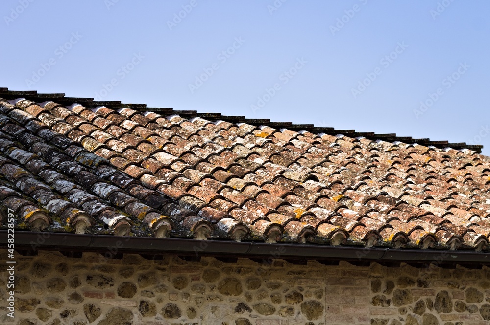 The roof with brick tiles of a farm in the Italian countryside (Umbria, Italy, Europe) The roof with brick tiles of a farm in the Italian countryside (Umbria, Italy, Europe)