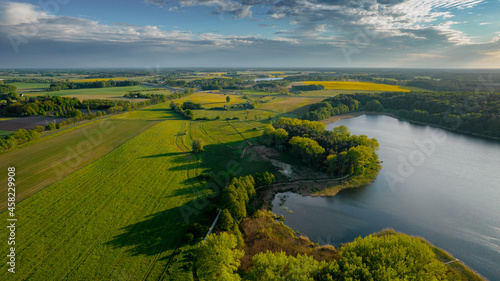 Fototapeta Naklejka Na Ścianę i Meble -  Aerial view of blue lakes and green forests on a sunny summer day in Poland. drone photography