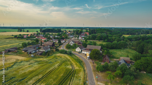 Aerial photo of a typical Polish hosing estate in the mountains towns, taken on a sunny part cloudy day using a drone, showing the housing estate and farmers fields.