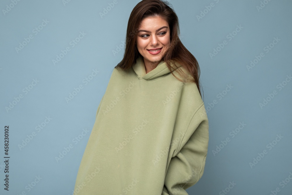 Attractive young woman in a khaki hoodie. Mock-up. Copy space Attractive young woman in a khaki hoodie. Mock-up. Copy space
