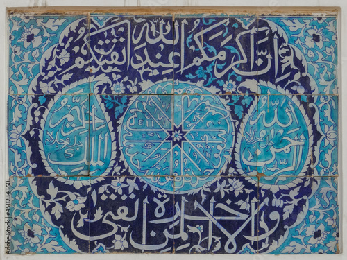 Beautiful ancient blue and white ceramic tile panel with religious arabic calligraphy on wall of landmark Bahauddin Zakariya tomb and shrine, Multan, Punjab, Pakistan photo