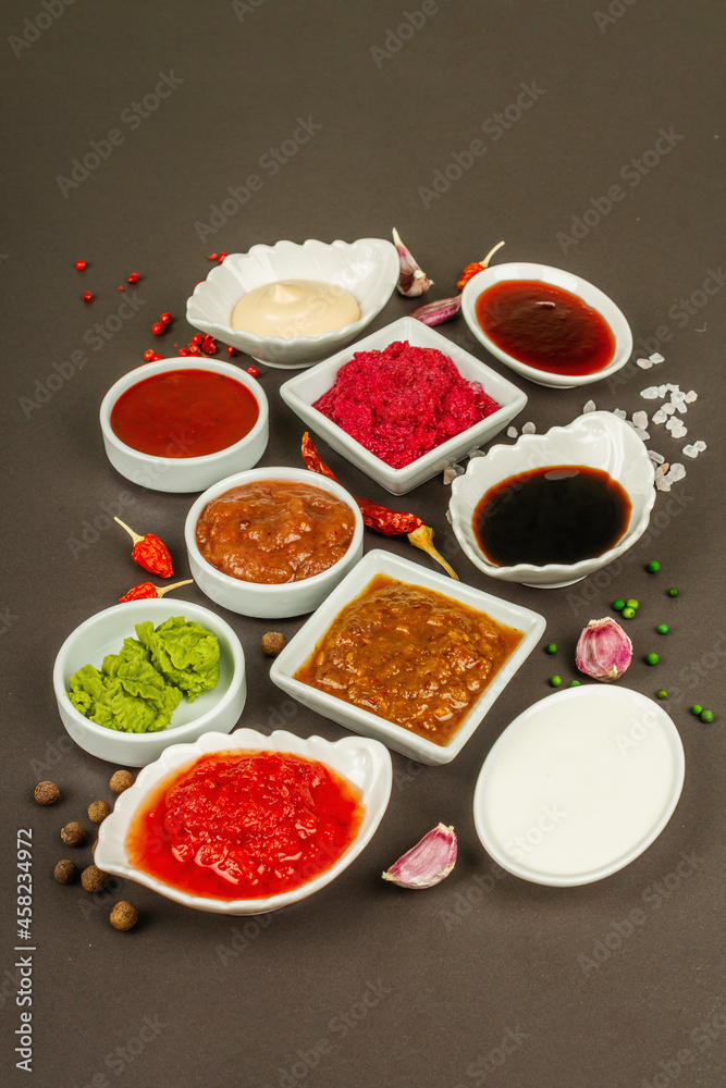 Set of different sauces - ketchup, mayonnaise, barbecue, soy, chutney, wasabi, adjika, horseradish