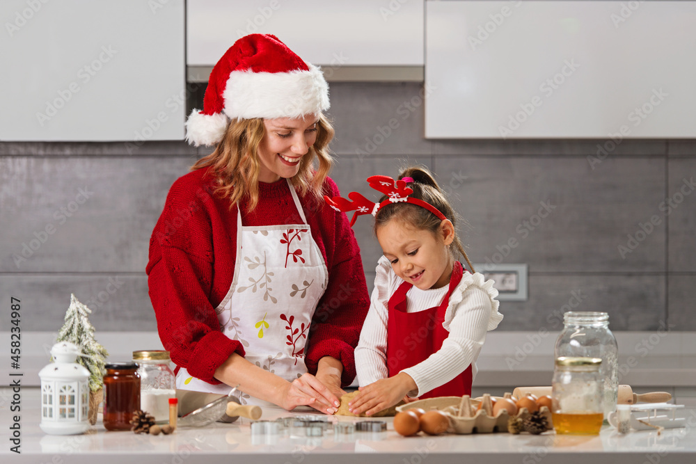 Mother and daughter making Christmas cookies in the kitchen Mother and daughter making Christmas cookies in the kitchen