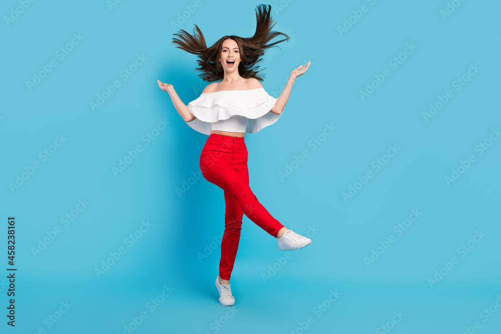 Fototapeta premium Full length photo of funny brunette young lady dance wear blouse jeans isolated on blue color background