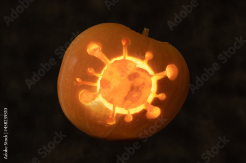 Halloween pumpkin with coronavirus carved inside © Marcin