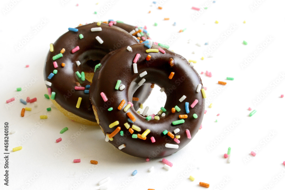 Chocolate glazed mini donuts on a white background
