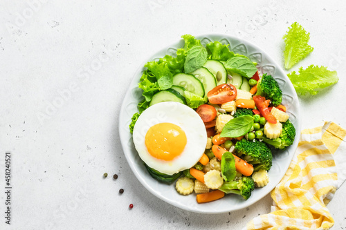 Light low calorie keto lunch egg vegetables bowl. Top view, space for text.
