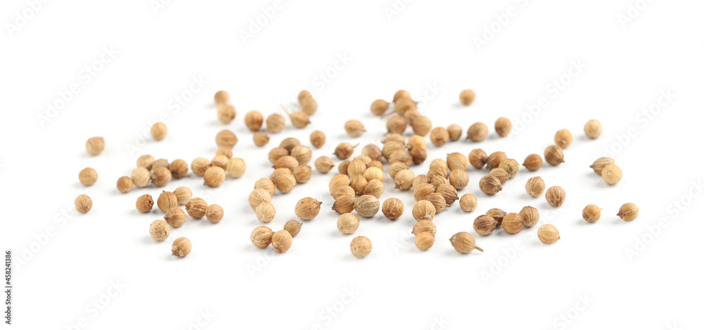 Scattered dried coriander seeds on white background Scattered dried coriander seeds on white background