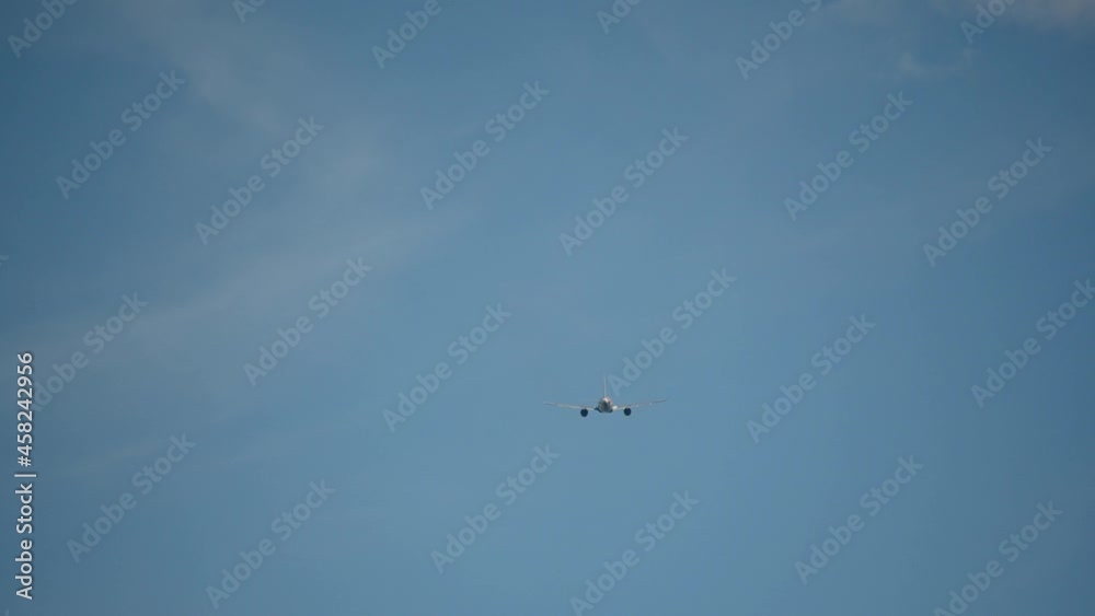 Airplane flying away against blue sky. Aircraft taking off and ascending. Travel concept. Real time, handheld Airplane flying away against blue sky. Aircraft taking off and ascending. Travel concept. Real time, handheld
