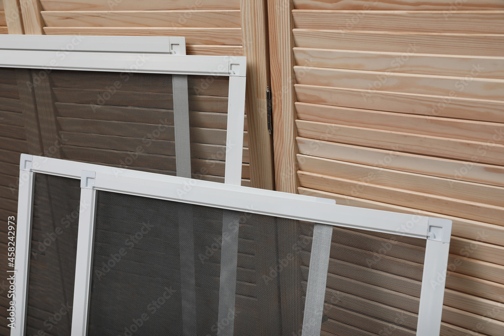 Set of window screens near wooden folding screen Set of window screens near wooden folding screen