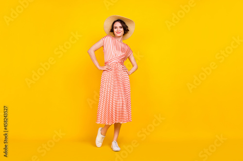 Full length body size view of attractive cheerful girl posing hands on hips weekend isolated over bright yellow color background
