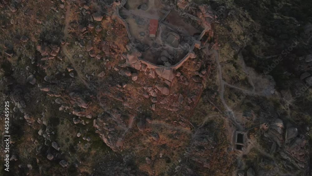 Monsanto castle ruins at sunrise, Portugal.Aerial top-down forward Monsanto castle ruins at sunrise, Portugal.Aerial top-down forward