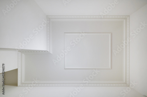 corner of ceiling and walls with intricate crown moulding. Interior construction and renovation concept.