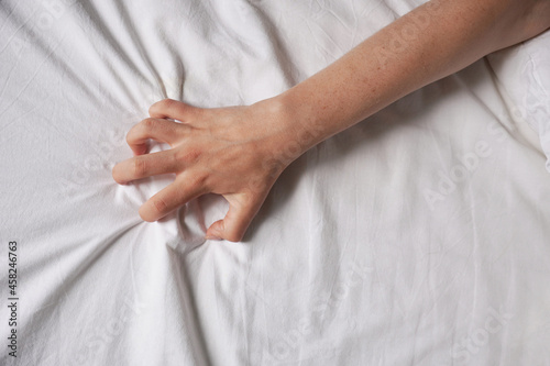 Quadro su tela female hand grabs bed sheet