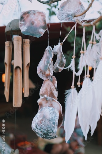Close up of different kinds of wind music. Traditional wind music with bamboo, shells, feathers. Tribal culture wind sound.