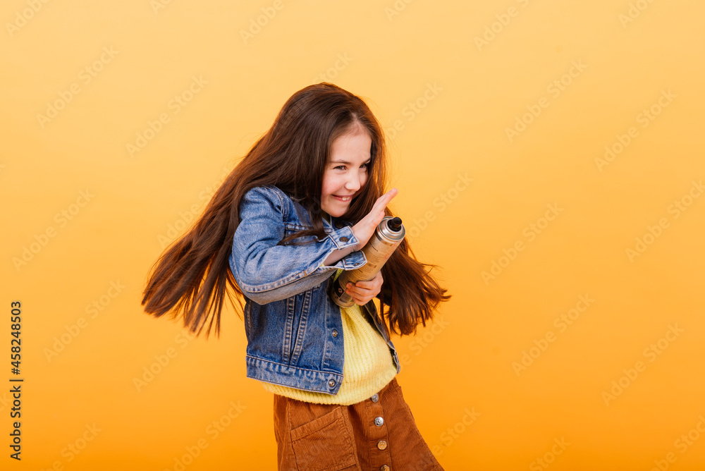 Close-up portrait of a cute little girl. Studio shot over yellow background. Childhood concept. Close-up portrait of a cute little girl. Studio shot over yellow background. Childhood concept.
