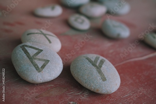 Close up of rune stones. Magic stones with runes on it. Witchcraft aesthetic tools.