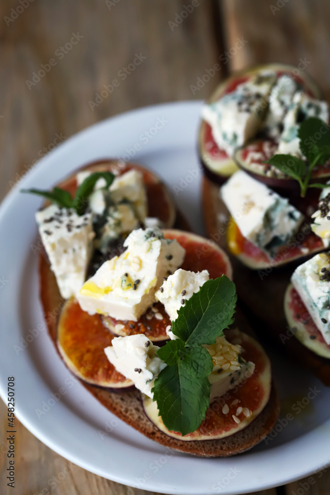 Selective focus. Sandwiches with figs and dor blue cheese.