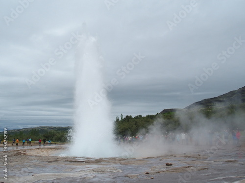 The mighty Strokkur shoots meter-high fountains of hot water and steam into the air, Haukaladur, Iceland