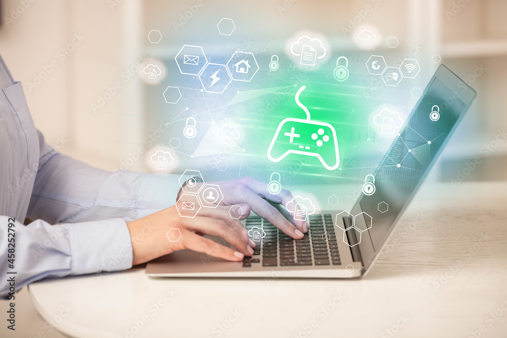 Hands working on laptop with digital icons Hands working on laptop with digital icons