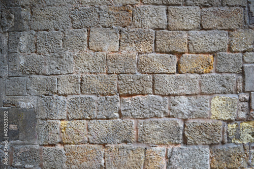 Wall texture with big bricks, ancient wall of a building in gothic area of Barcelona , Spain