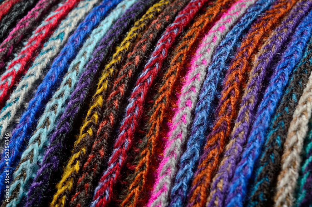 knitted multi-colored yarn. close-up. knitted multi-colored yarn. close-up.