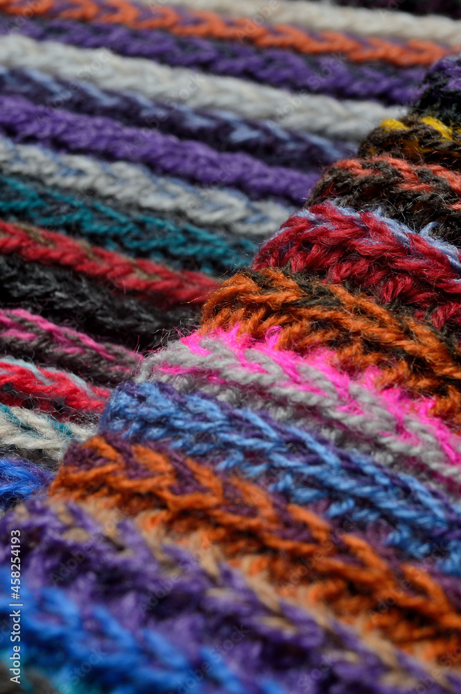 knitted multi-colored yarn. close-up. knitted multi-colored yarn. close-up.