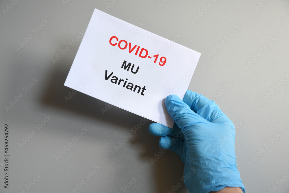 Doctor's hand in blue glove with white paper and text Covid-19 Mu Variant. Concept of medical variety Mu variant and COVID-19. Concept words 'mu variant'. COVID-19 mu variant concept. Doctor's hand in blue glove with white paper and text Covid-19 Mu Variant. Concept of medical variety Mu variant and COVID-19. Concept words 'mu variant'. COVID-19 mu variant concept.