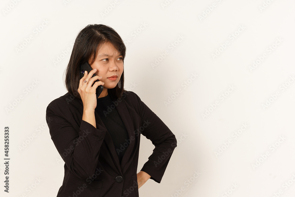 Beautiful Asian Woman Wearing black suit Talking on mobile phone with Serious facial expression Isolated on white background Beautiful Asian Woman Wearing black suit Talking on mobile phone with Serious facial expression Isolated on white background