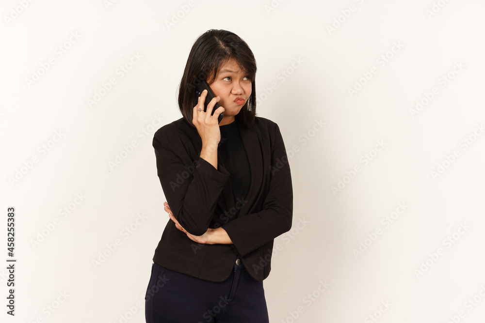Beautiful Asian Woman Wearing black suit Talking on mobile phone with Serious facial expression Isolated on white background Beautiful Asian Woman Wearing black suit Talking on mobile phone with Serious facial expression Isolated on white background