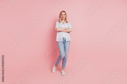 Full size photo of youg attractive woman happy positive smile crossed hands isolated over pink color background